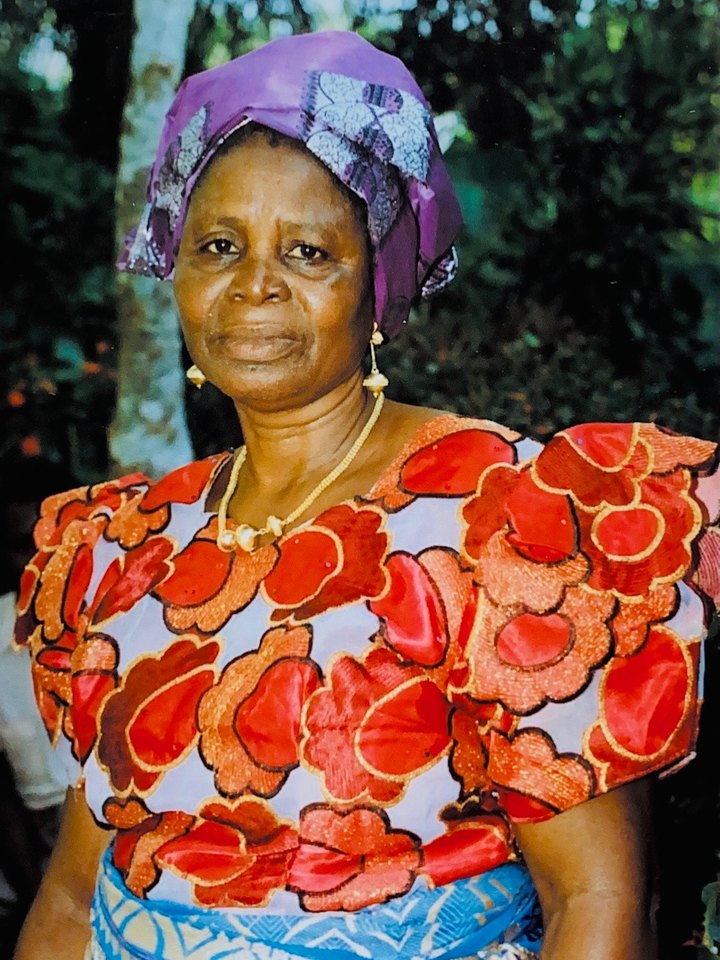 Ezinne Regina Okeigbo in a purple headwrap and a red floral blouse
